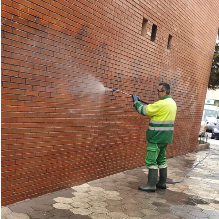 Un operario del servicio de limpieza elimina un grafiti